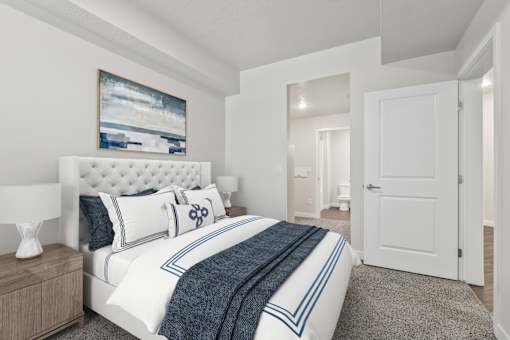 A bedroom with a large bed and a painting on the wall.