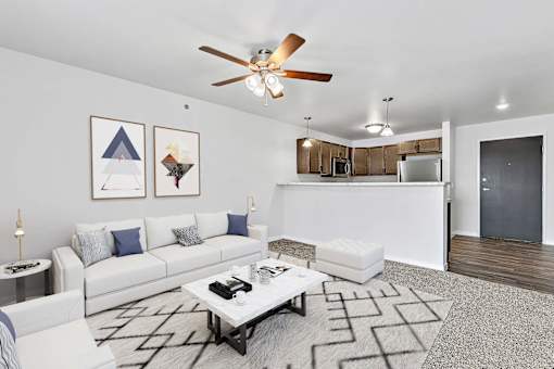 a living room with white couches and a coffee table at Red Rock Apartments, Rapid City, South Dakota