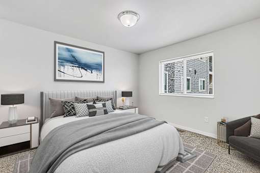 a bedroom with a large bed and two windows at Red Rock Apartments, Rapid City, SD, 57702