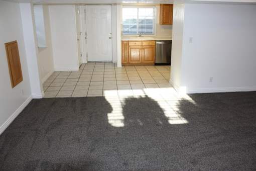 A kitchen area with a sink and a window.