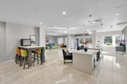 a kitchen and living room with a bar and chairs and a dining room table