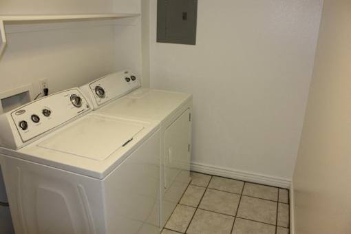 A white washer and dryer in a small laundry room.