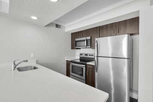 a kitchen with stainless steel appliances and a white counter top
