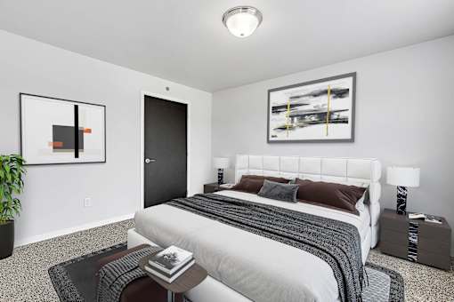 a bedroom with a large bed in a 555 waverly unit at Red Rock Apartments, Rapid City, SD