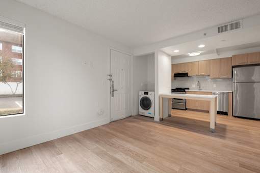 A modern kitchen with wooden floors and stainless steel appliances at AVIA Lofts on Parkway Apartments, Vancouver, Washington