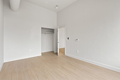 A room with a white wall and a wooden floor.