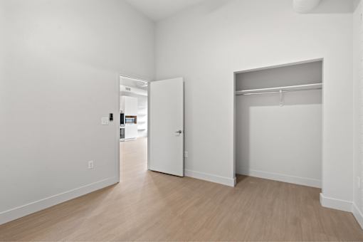 A white room with a door and a window.