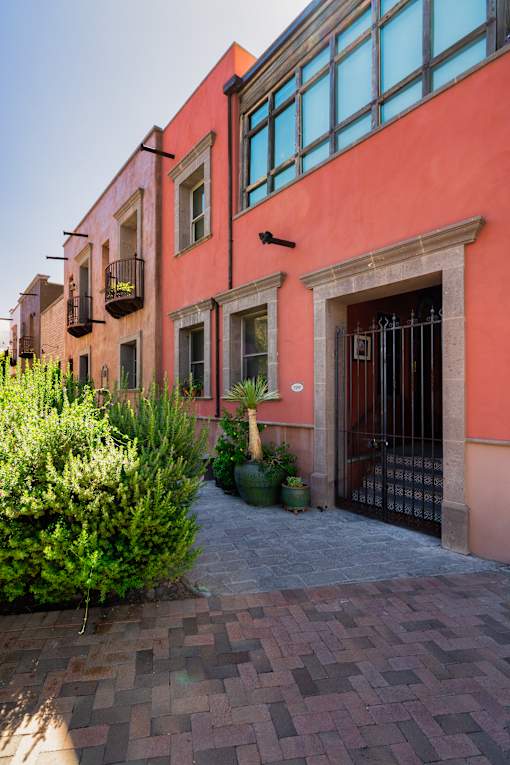 Red building exterior at Bautista Apartments, Tucson, AZ