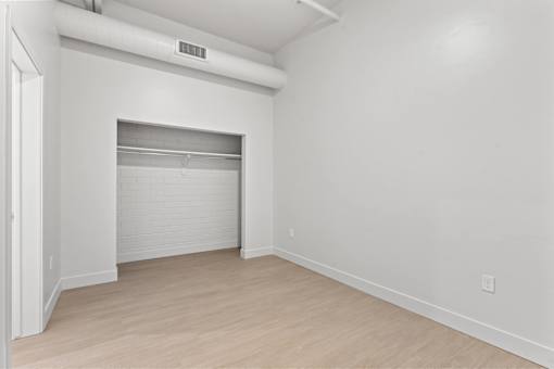A white room with a sliding door and a white wall.
