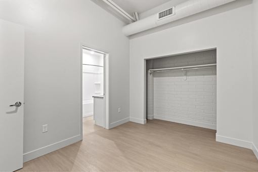 A white room with a door and a window.