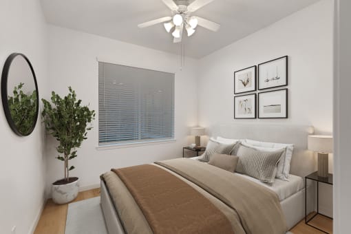 a bedroom with a large bed and a ceiling fan