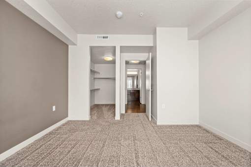a spacious living room with gray walls and a carpeted floor at Wilmington Flats Apartments, Salt Lake City