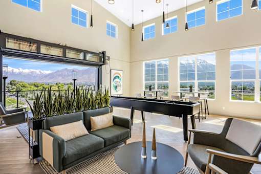 A living room with a pool table and a view of the mountains.