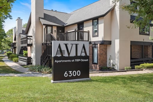 an apartments sign in front of an apartment building