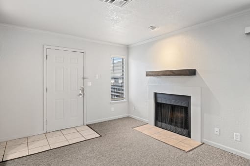 a living room with a fireplace and a white door