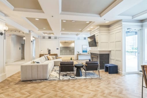 a living room with a couch and chairs and a fireplace