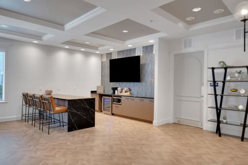 a living room with a bar and a tv on the wall