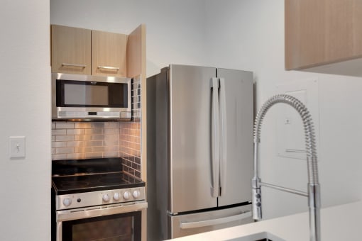a kitchen with stainless steel appliances and a refrigerator