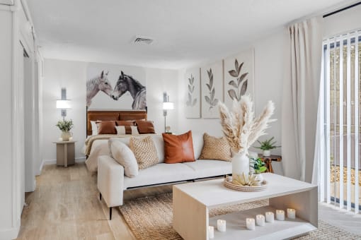 a living room with a couch and a bed at AVIA Lofts on Liberty Ridge, Jacksonville, FL, 32256