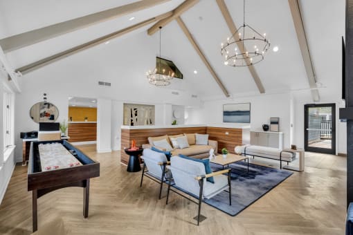 a living room with furniture and a pool table at AVIA Lofts on Liberty Ridge, Jacksonville, FL, 32256
