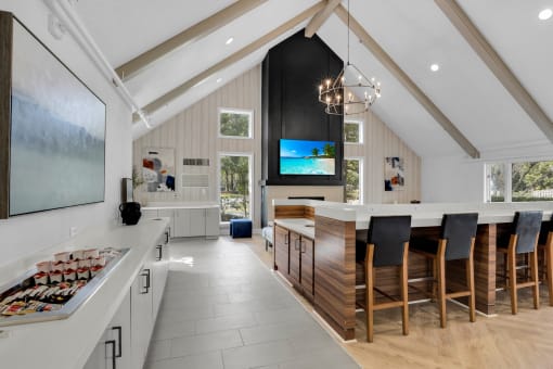 a kitchen with a large island and a table with chairs at AVIA Lofts on Liberty Ridge, Florida