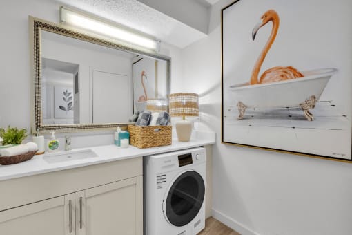a laundry room with a sink and a washing machine and a mirror and a tub at AVIA Lofts on Liberty Ridge, Florida, 32256