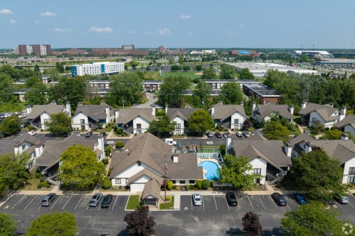 an aerial view of a neighborhood with houses and a swimming pool