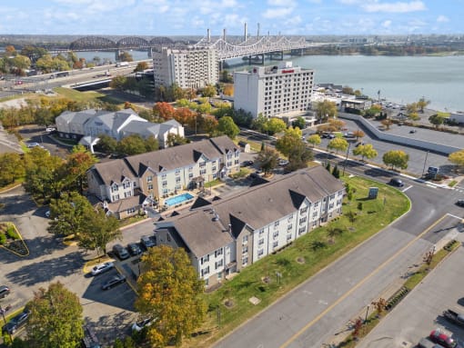 an aerial view of houses and a river and a bridge