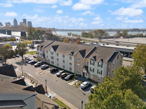 an aerial view of an apartment complex with a river in the background