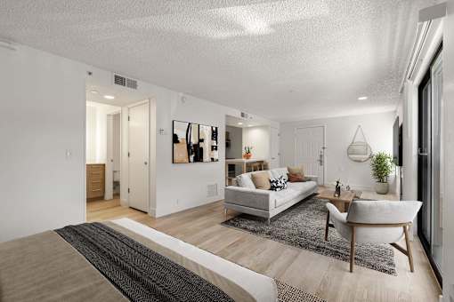 A modern living room with a white couch and a coffee table.