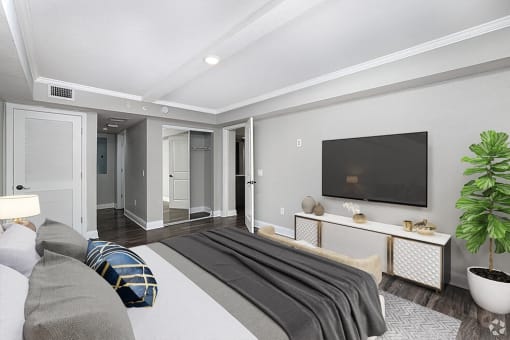 a bedroom with a bed and a tv