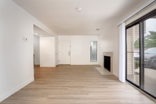 a bedroom with hardwood floors and white walls