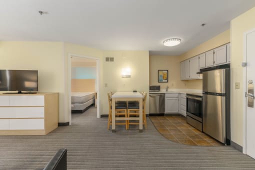 a kitchen and dining area in a hotel room