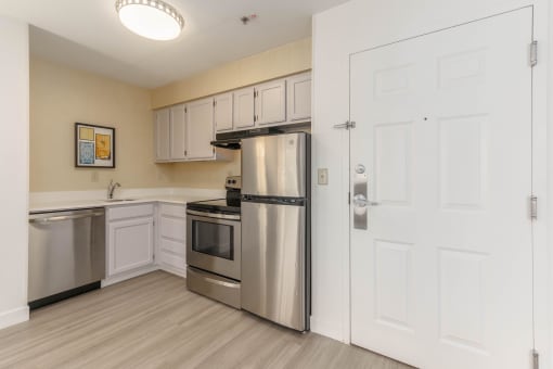 a kitchen with stainless steel appliances and white cabinets