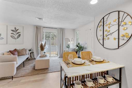 a living room and dining room with a table and chairs at AVIA Lofts on Liberty Ridge, Florida