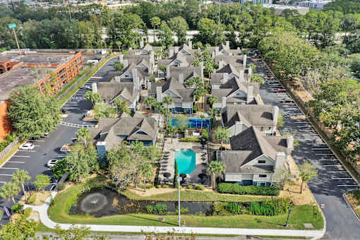 an aerial view of a neighborhood with houses and a swimming pool at AVIA Lofts on Liberty Ridge, Jacksonville, FL