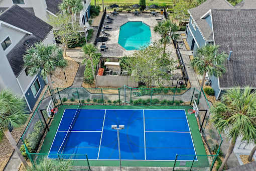an aerial view of a tennis court and a pool in a house at AVIA Lofts on Liberty Ridge, Florida, 32256