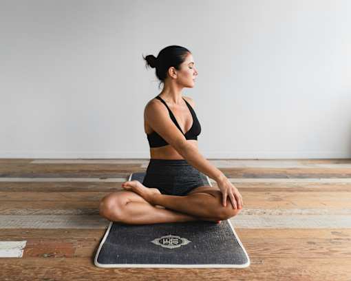 A woman is doing yoga at Bautista Apartments, Arizona