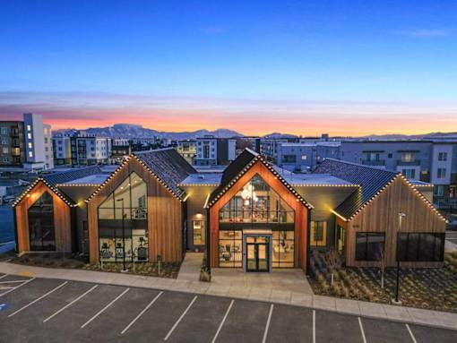 A building with a parking lot in front of it.
