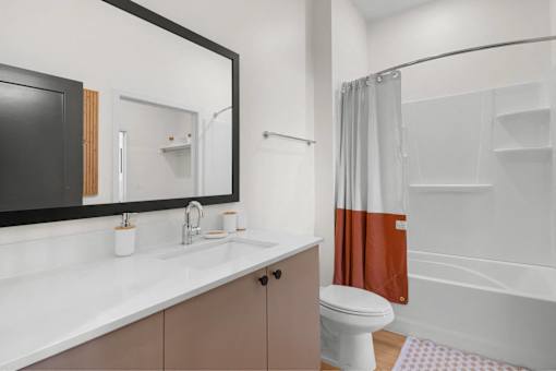 A bathroom with a white sink and a white toilet.