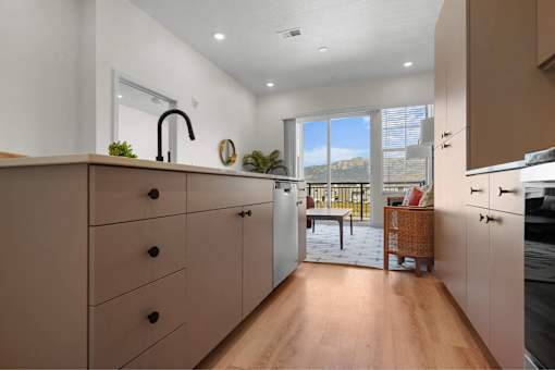 A kitchen with wooden cabinets and a black faucet.