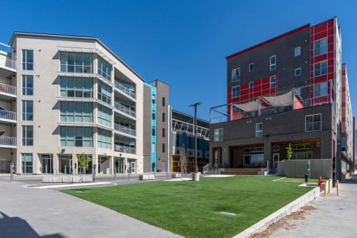 a group of modern buildings and a lawn in front of a sidewalk at Paperbox Lofts, Salt Lake City, 84101