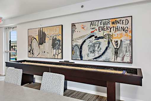 a room with a pool table and two paintings on the wall at Red Rock Apartments, Rapid City