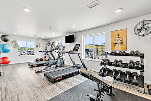 a workout room with treadmills and other exercise equipment at Red Rock Apartments, South Dakota 57702
