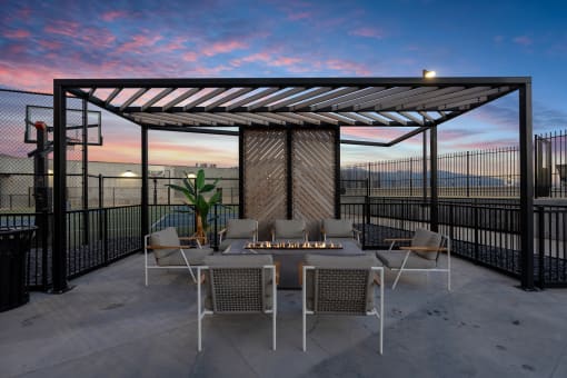 a patio with a table and chairs under a pergola at SevenO2 Main Apartments, Salt Lake City, Utah