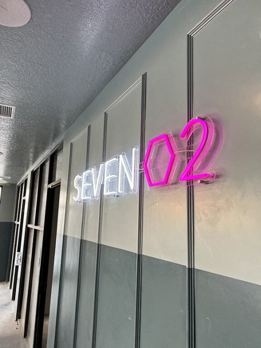 a neon sign on the side of a door at SevenO2 Main Apartments, Salt Lake City, Utah