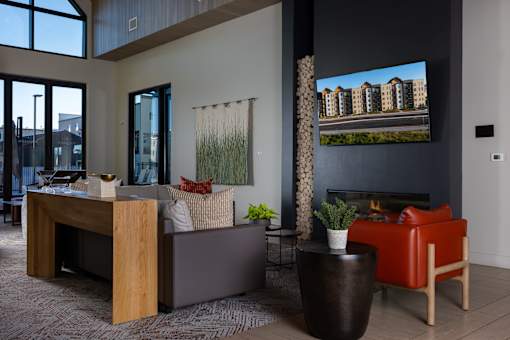 A modern living room with a fireplace and a large TV screen at Solhavn Apartments, American Fork, 84003