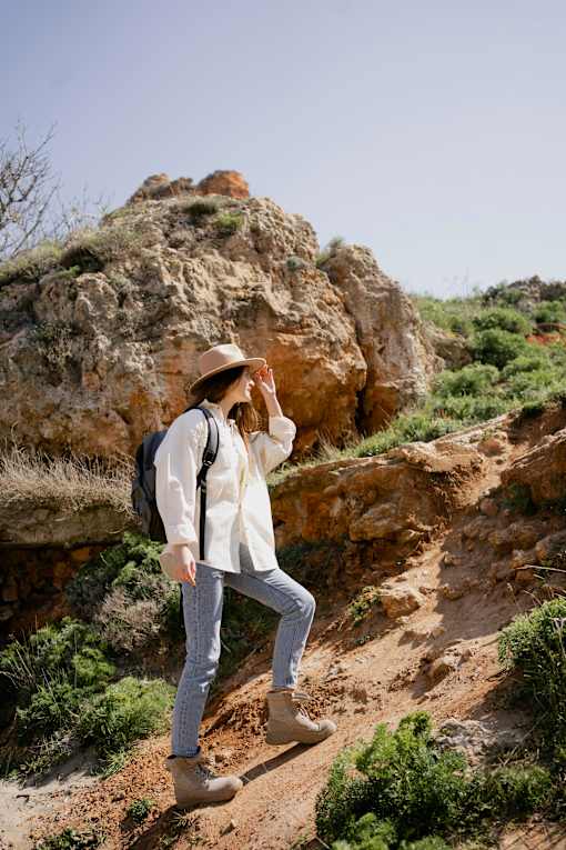 A woman is standing on a rocky hill at Bautista Apartments, Arizona, 85745