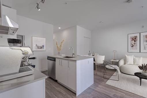A modern kitchen with a dishwasher, sink, and refrigerator.