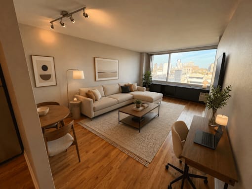 A modern living room with a large window overlooking the city.